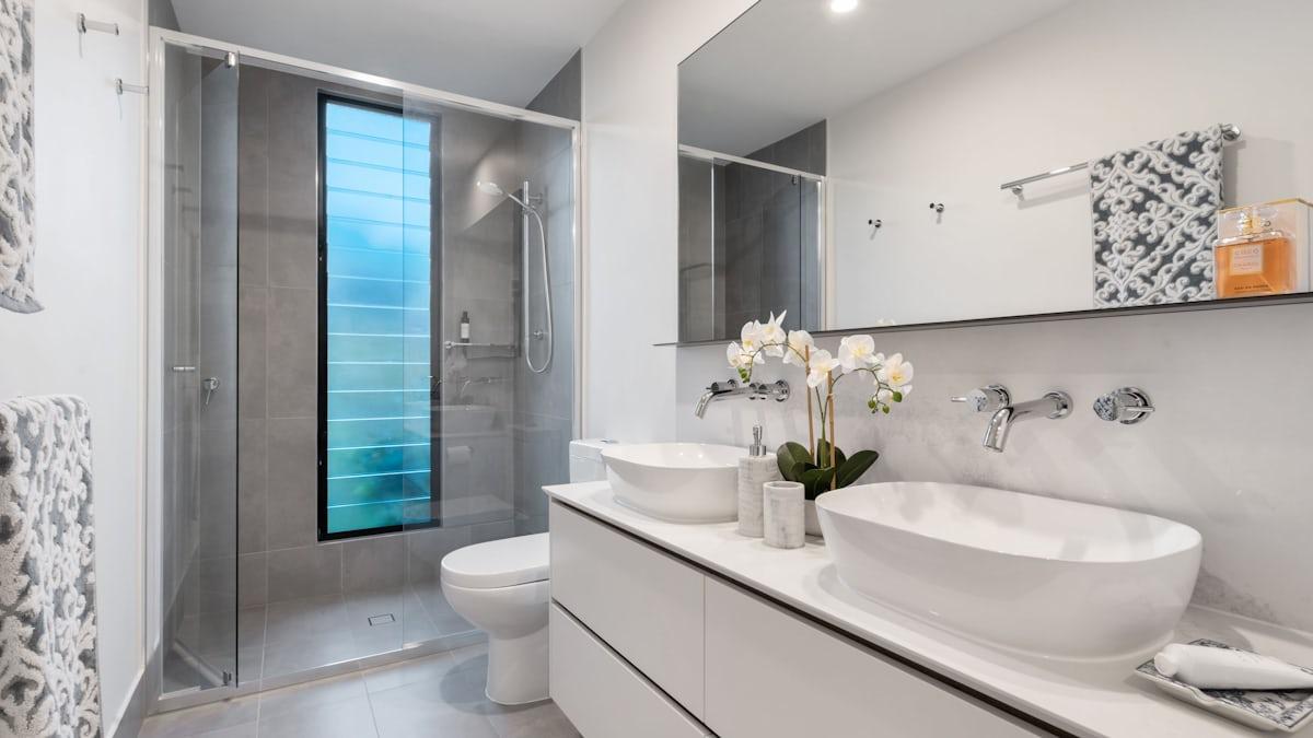 Renovated modern bathroom interior with full tiling